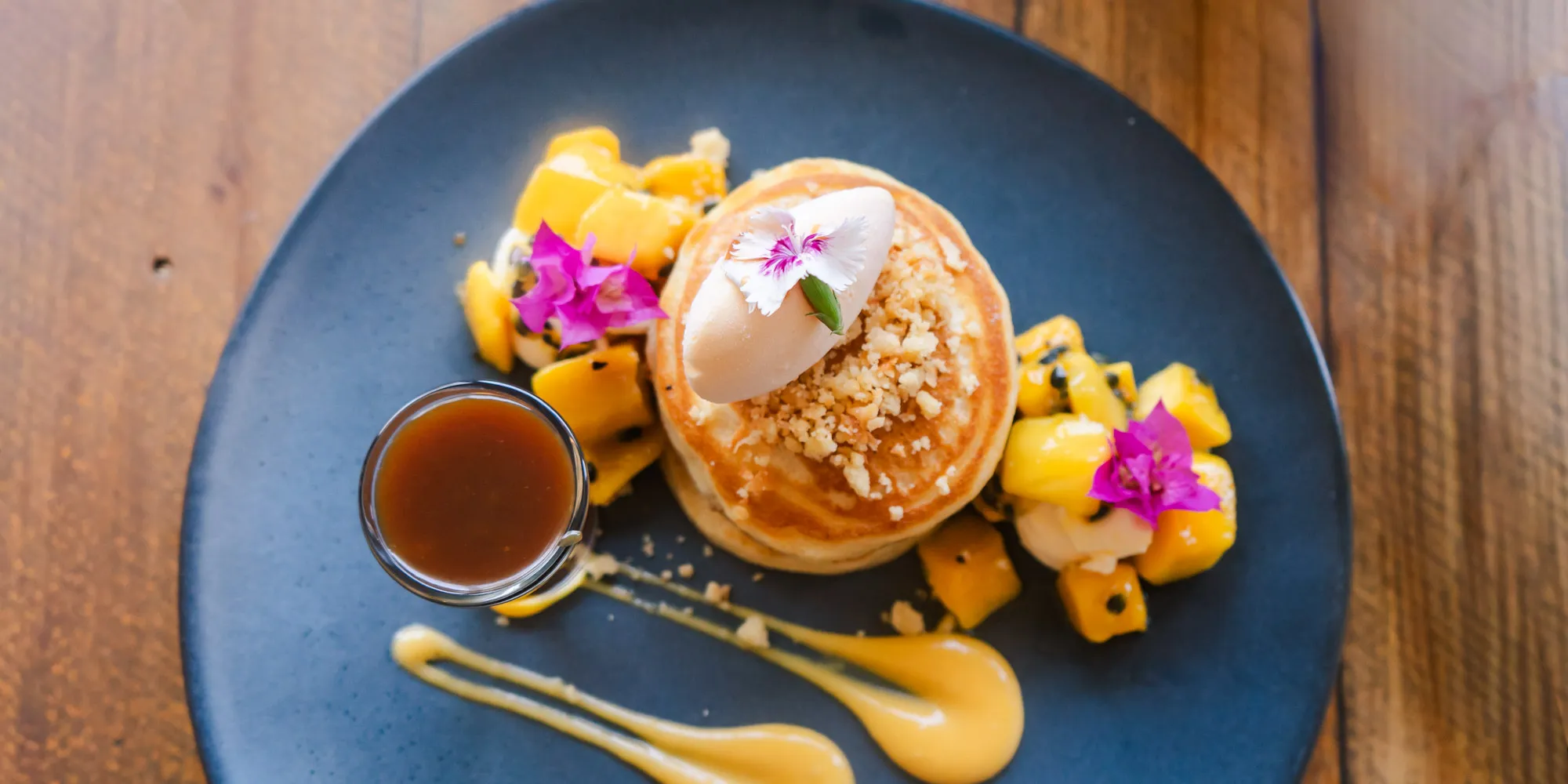 A stack of the best pancakes in Perth, topped with hazelnuts and chocolate from Laika in Lathlain