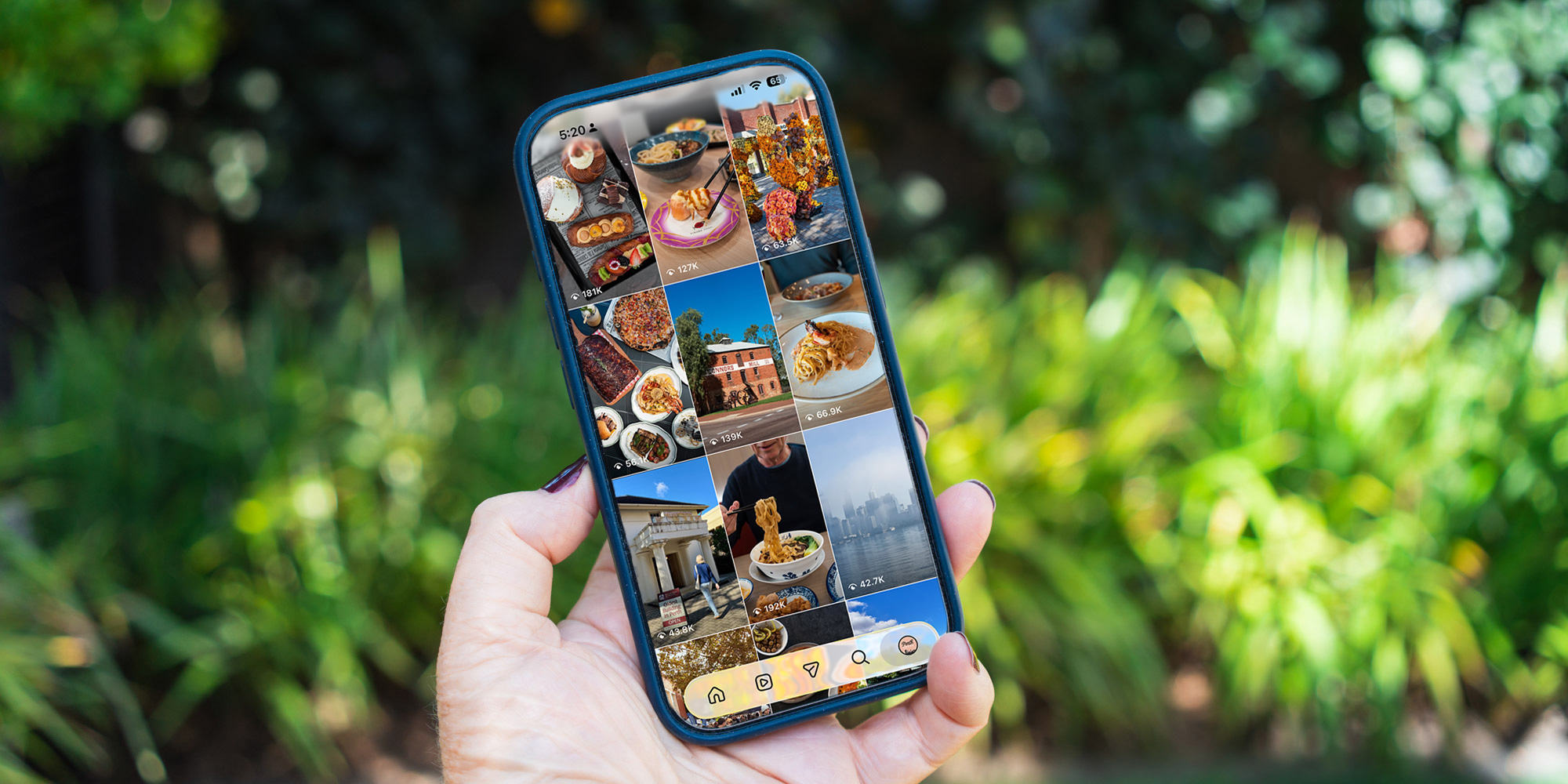 Perth Local’s Instagram grid, a mix of food, travel and lifestyle content, open on a phone held up in a garden